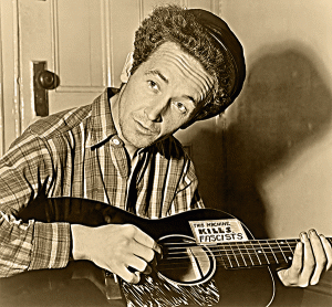 Woody, with his guitar labeled "This Machine Kills Fascists"